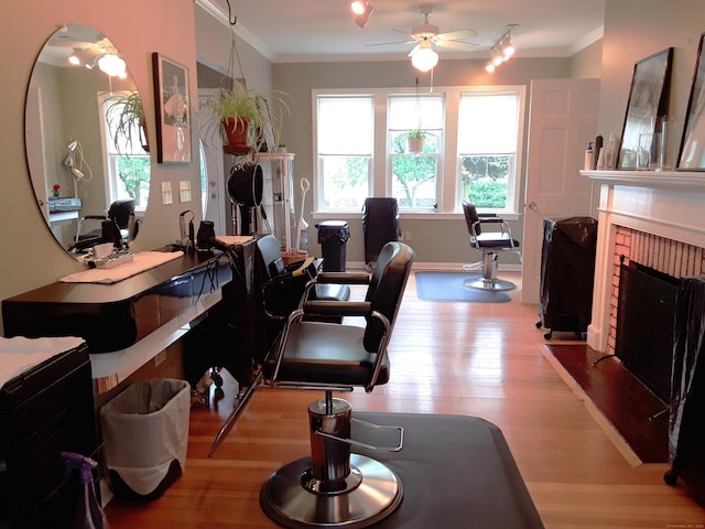 189 E Ave, Norwalk, CT 06855 - living room featuring plenty of natural light, wood finished floors, crown molding, a brick fireplace, and a ceiling fan