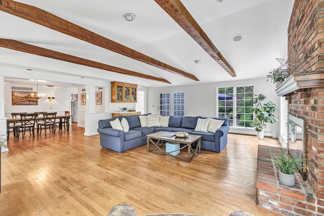 73 Golden Hill St, Trumbull, CT 06611 - living room with beam ceiling, a fireplace, light wood-style flooring, and a chandelier