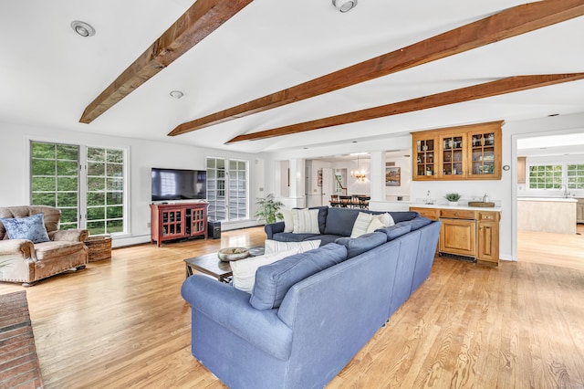 73 Golden Hill St, Trumbull, CT 06611 - living room with light wood finished floors, beamed ceiling, a chandelier, and decorative columns