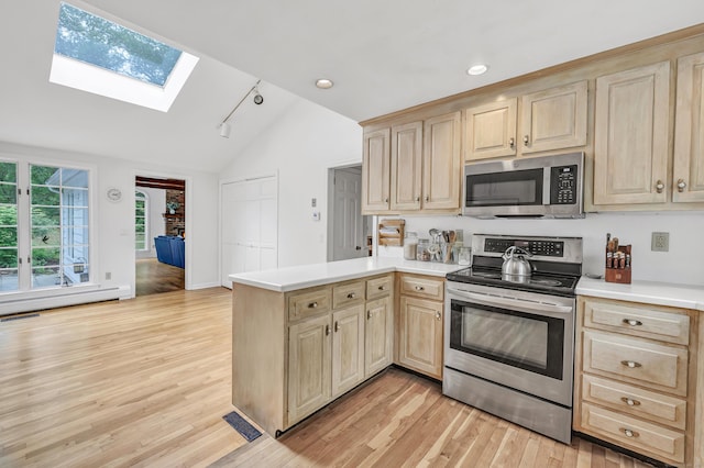 73 Golden Hill St, Trumbull, CT 06611 - kitchen featuring appliances with stainless steel finishes, light brown cabinetry, a skylight, lofted ceiling, and light countertops
