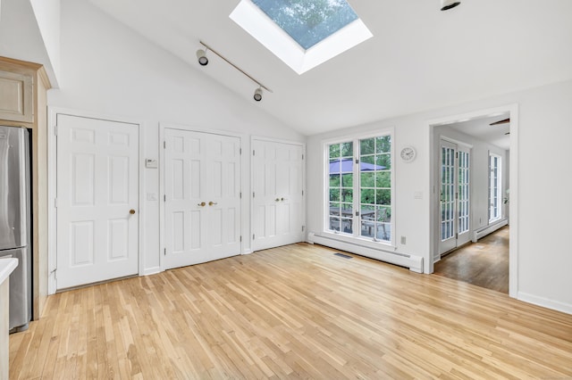 73 Golden Hill St, Trumbull, CT 06611 - unfurnished bedroom with a skylight, a baseboard radiator, freestanding refrigerator, light wood-style floors, and high vaulted ceiling