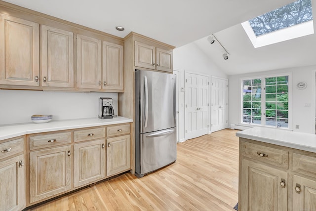 73 Golden Hill St, Trumbull, CT 06611 - kitchen featuring light brown cabinets, freestanding refrigerator, a skylight, and vaulted ceiling