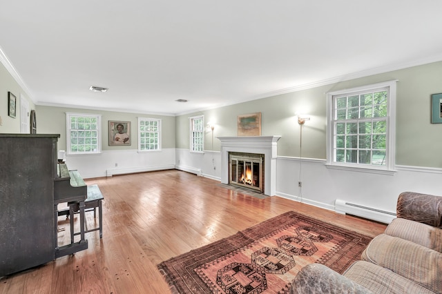 73 Golden Hill St, Trumbull, CT 06611 - living area with baseboard heating, a fireplace with flush hearth, wood finished floors, ornamental molding, and a wainscoted wall