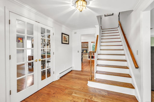 73 Golden Hill St, Trumbull, CT 06611 - stairs with french doors, a baseboard heating unit, hardwood / wood-style floors, ornamental molding, and baseboards