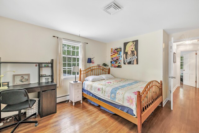 73 Golden Hill St, Trumbull, CT 06611 - bedroom featuring wood finished floors, baseboard heating, and an office area