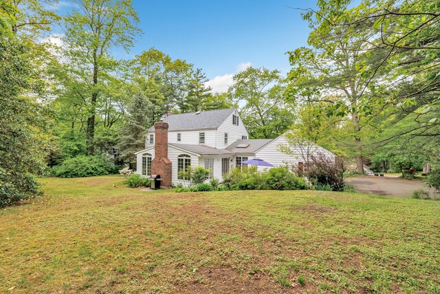 73 Golden Hill St, Trumbull, CT 06611 - view of front of house featuring a chimney and a front lawn