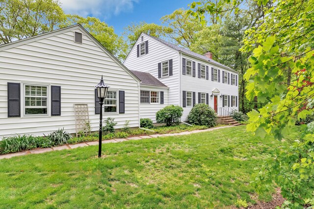 73 Golden Hill St, Trumbull, CT 06611 - colonial house featuring a front yard and a chimney