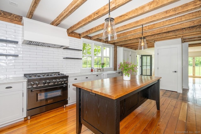 99 Sharon Mountain Rd, Sharon, CT 06069 - kitchen with stainless steel range, wood counters, premium range hood, open shelves, and white cabinetry