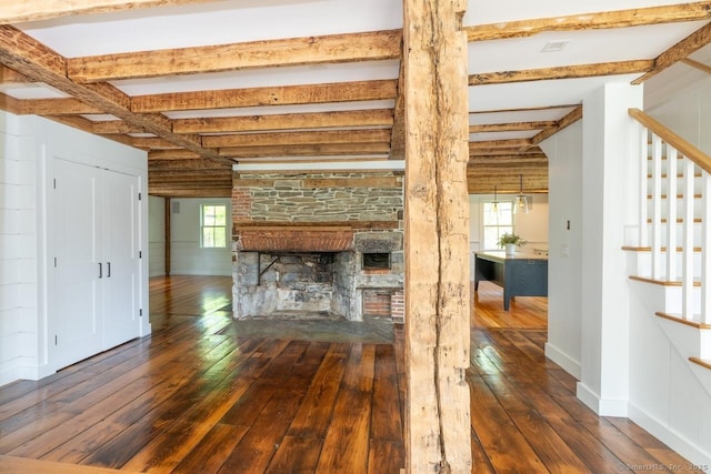 99 Sharon Mountain Rd, Sharon, CT 06069 - unfurnished living room with plenty of natural light, hardwood / wood-style floors, stairs, beamed ceiling, and a stone fireplace