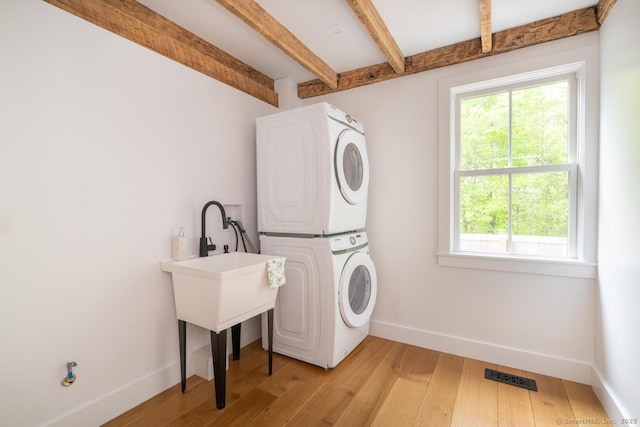 99 Sharon Mountain Rd, Sharon, CT 06069 - laundry room featuring stacked washer / dryer, baseboards, and light wood-type flooring