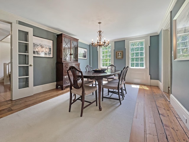 114 Ruscoe Rd, Wilton, CT 06897 - dining room featuring hardwood / wood-style flooring, crown molding, a chandelier, and baseboards