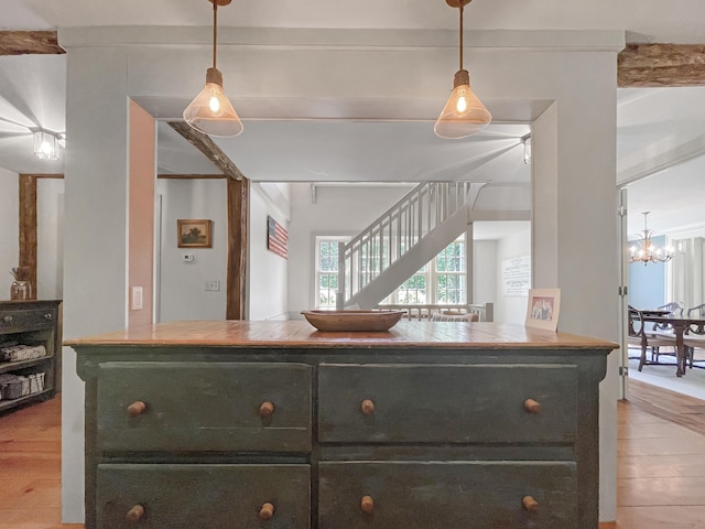 114 Ruscoe Rd, Wilton, CT 06897 - kitchen with light wood-style flooring, hanging light fixtures, a chandelier, and dark cabinets