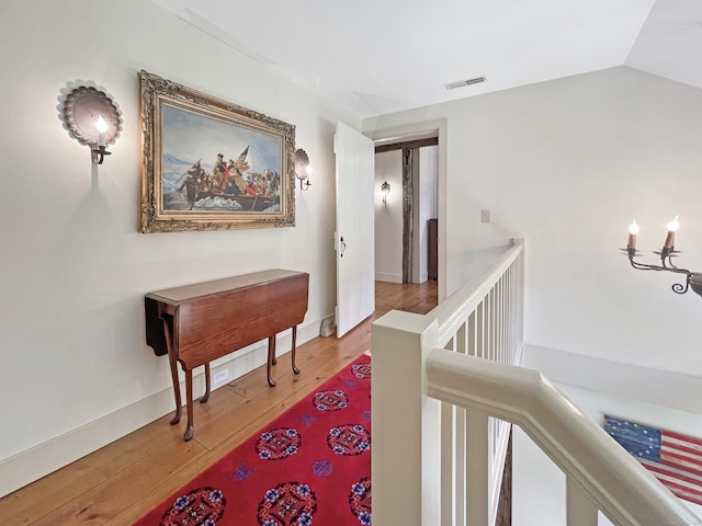 114 Ruscoe Rd, Wilton, CT 06897 - corridor featuring an upstairs landing, wood finished floors, and vaulted ceiling