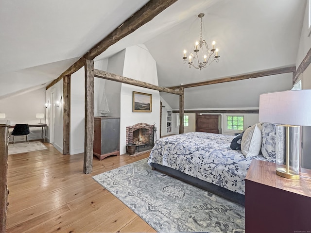 114 Ruscoe Rd, Wilton, CT 06897 - bedroom featuring a brick fireplace, light wood-style flooring, a chandelier, beam ceiling, and high vaulted ceiling