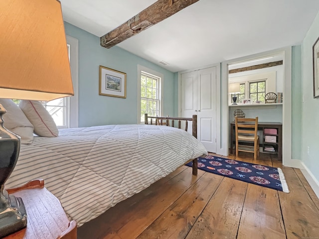 114 Ruscoe Rd, Wilton, CT 06897 - bedroom with hardwood / wood-style floors, multiple windows, beam ceiling, baseboards, and a closet