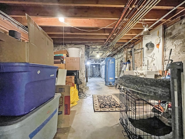 114 Ruscoe Rd, Wilton, CT 06897 - unfinished basement with a water pressure tank and a sink