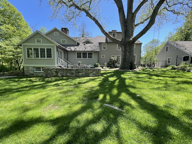 114 Ruscoe Rd, Wilton, CT 06897 - rear view of property featuring a chimney and a yard