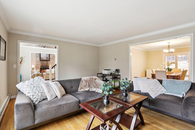 8 Grants Ln, New Milford, CT 06776 - living room with a baseboard radiator, a chandelier, light wood-type flooring, crown molding, and a fireplace