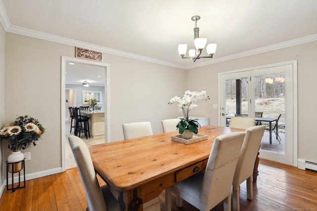 8 Grants Ln, New Milford, CT 06776 - dining space featuring a chandelier, ornamental molding, light wood finished floors, and baseboards