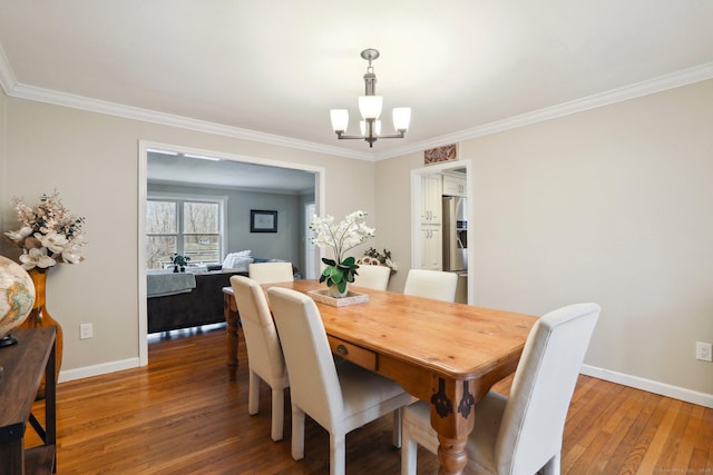 8 Grants Ln, New Milford, CT 06776 - dining room with a chandelier, crown molding, wood finished floors, and baseboards