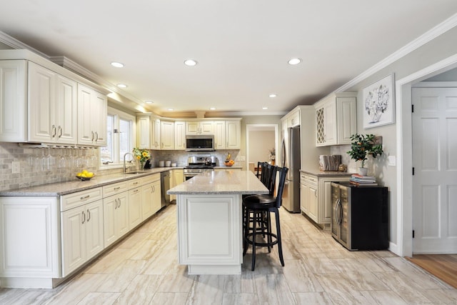8 Grants Ln, New Milford, CT 06776 - kitchen featuring appliances with stainless steel finishes, a sink, a kitchen breakfast bar, ornamental molding, and a center island