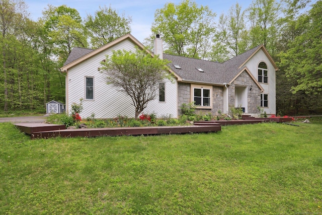 8 Grants Ln, New Milford, CT 06776 - view of front of house featuring stone siding, a shed, a chimney, a front yard, and an outdoor structure