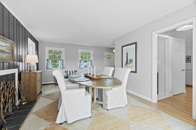 410 Noank Rd, Groton, CT 06355 - dining area with wood finished floors, baseboards, and baseboard heating