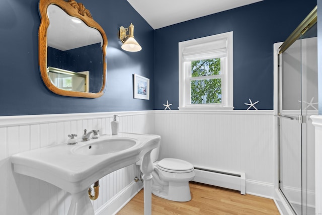 410 Noank Rd, Groton, CT 06355 - full bathroom with a baseboard radiator, wainscoting, wood finished floors, toilet, and a shower stall