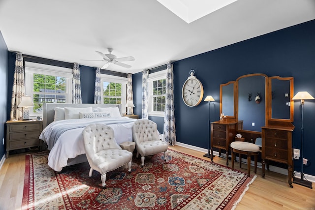 410 Noank Rd, Groton, CT 06355 - bedroom with wood finished floors, baseboards, a ceiling fan, and a skylight