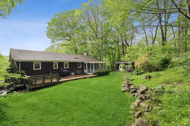 14 Button Rd, Shelton, CT 06484 - rear view of house with a sunroom, a chimney, a lawn, a deck, and roof with shingles