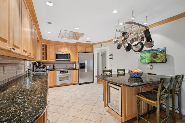 14 Button Rd, Shelton, CT 06484 - kitchen with stainless steel appliances, a sink, beverage cooler, a skylight, and ornamental molding