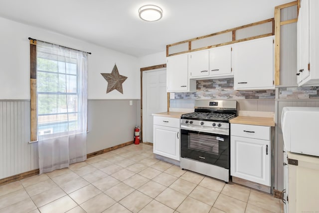 56 Gem Ave, Bridgeport, CT 06606 - kitchen featuring stainless steel gas range, light countertops, white cabinets, and a wainscoted wall
