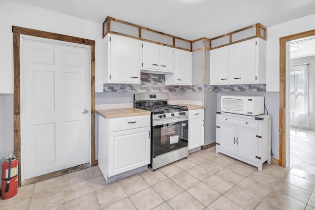 56 Gem Ave, Bridgeport, CT 06606 - kitchen featuring gas stove, white microwave, light countertops, and white cabinets