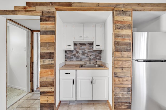 56 Gem Ave, Bridgeport, CT 06606 - kitchen featuring freestanding refrigerator, a sink, backsplash, and white cabinets