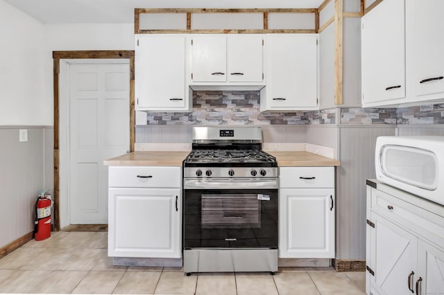 56 Gem Ave, Bridgeport, CT 06606 - kitchen featuring stainless steel range with gas stovetop, light countertops, white microwave, and white cabinetry