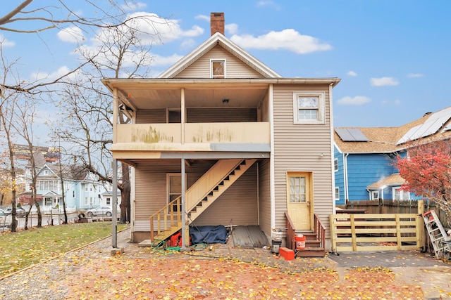 56 Gem Ave, Bridgeport, CT 06606 - rear view of house with entry steps, stairway, fence, a balcony, and a chimney