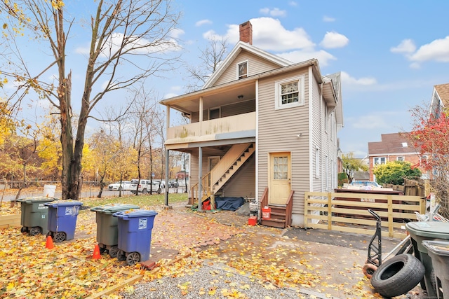 56 Gem Ave, Bridgeport, CT 06606 - back of property featuring a chimney, entry steps, fence, and stairway