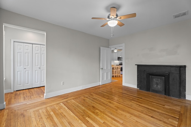 52 Edwards St, New Haven, CT 06511 - unfurnished living room with a ceiling fan, wood-type flooring, baseboards, and a fireplace