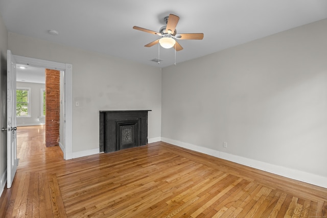 52 Edwards St, New Haven, CT 06511 - unfurnished living room featuring light wood-style flooring, baseboards, ceiling fan, and a fireplace