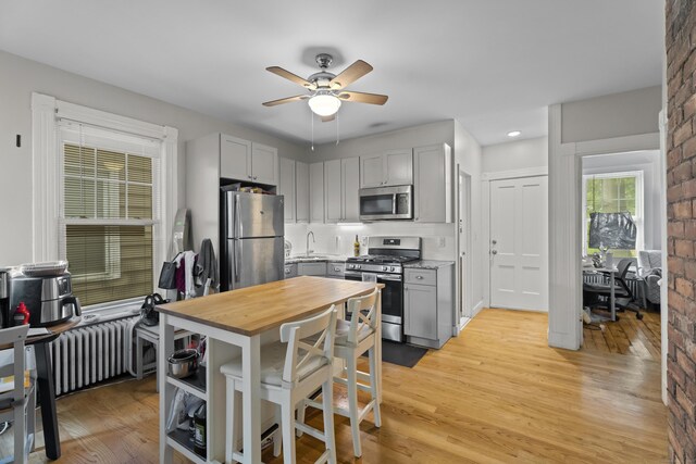 52 Edwards St, New Haven, CT 06511 - kitchen featuring appliances with stainless steel finishes, radiator, butcher block countertops, ceiling fan, and light wood-style floors