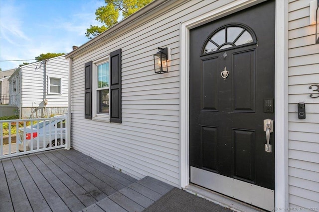 view of exterior entry featuring a deck