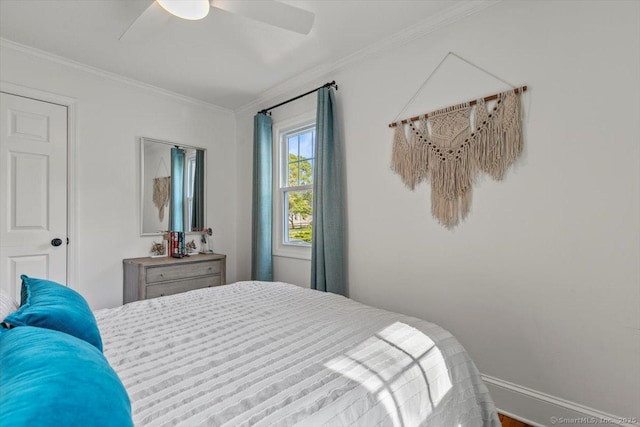 bedroom featuring crown molding, a ceiling fan, and baseboards