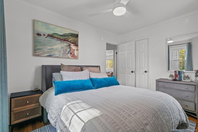 bedroom featuring wood finished floors, ornamental molding, and a ceiling fan