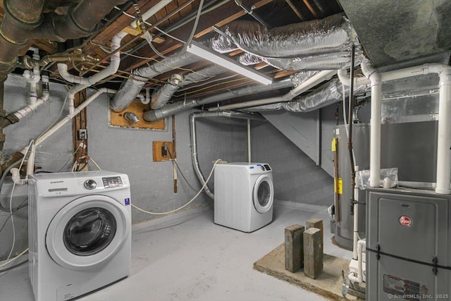 unfinished below grade area featuring gas water heater and washer and dryer