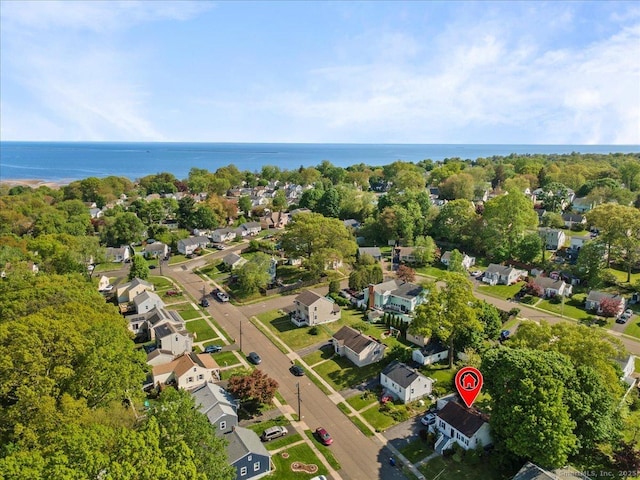 aerial overview of property's location with a nearby body of water and nearby suburban area