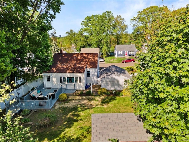 rear view of property featuring a wooden deck and a chimney