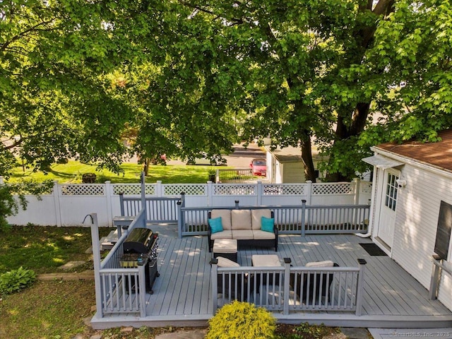 deck featuring an outdoor hangout area, fence, and a grill
