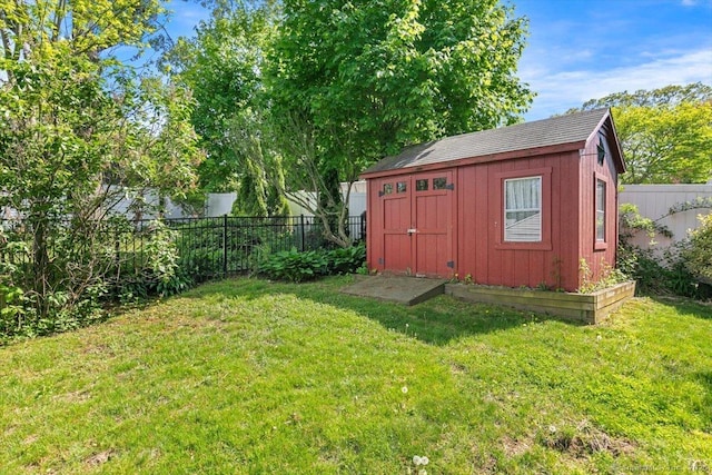 view of yard featuring a storage unit and an outbuilding