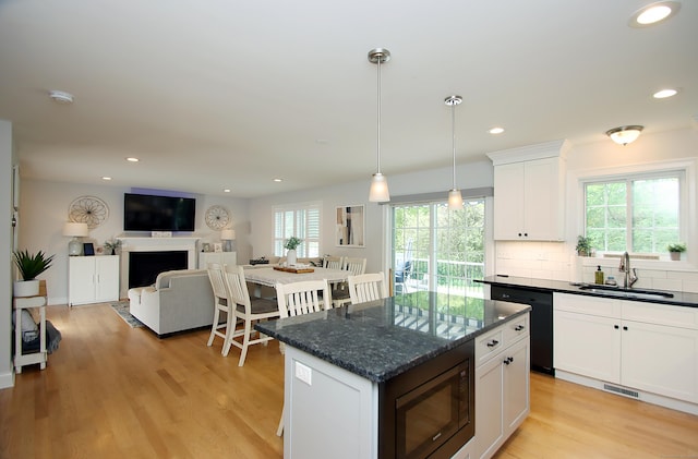 229 Long Hill Cross Rd, Shelton, CT 06484 - kitchen featuring black dishwasher, built in microwave, a sink, white cabinets, and light wood-style flooring