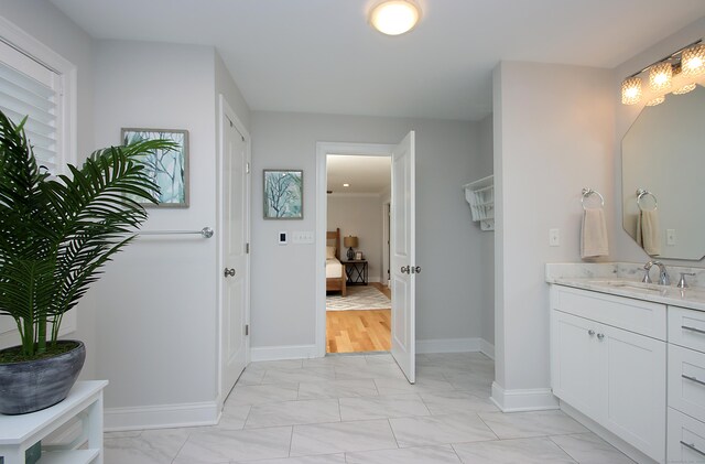 229 Long Hill Cross Rd, Shelton, CT 06484 - ensuite bathroom featuring marble finish floors, vanity, and baseboards